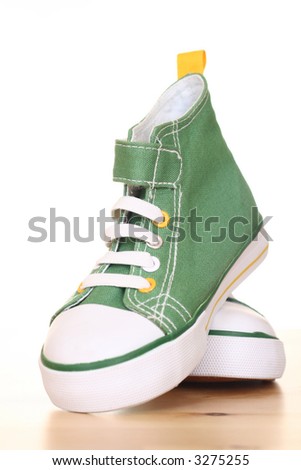 pair of green sneakers for children on the floor