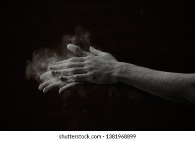 Pair of hands dusting of the powder