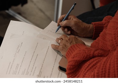 A pair of hands making notes