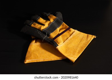 A Pair Of Heavy Duty Gloves On Black Background.