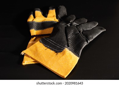 A Pair Of Heavy Duty Gloves On Black Background.