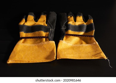 A Pair Of Heavy Duty Gloves On Black Background.