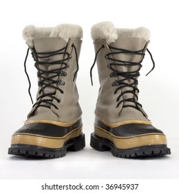 a pair of heavy snow boots on white background, low angle perspective