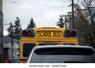 A Pair Of Images Showing The Same School Bus Two Cars Away From Camera. 