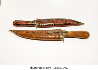Pair of Indian knives with wooden and brass handle and sheath.