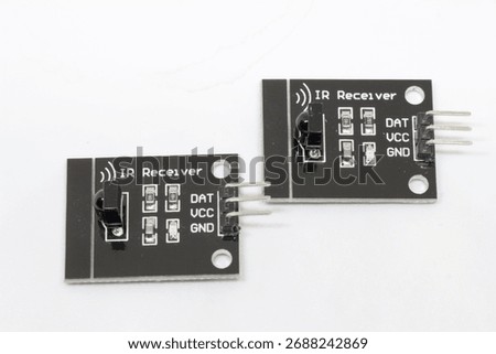 Pair of IR receiver modules side-by-side on a white background; black PCBs with 3-pin headers