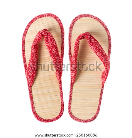 Pair of Japanese bamboo with red cloth  flip flops isolated on white background.