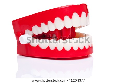 A pair of joke wind up chattering teeth on a pure white background, high resolution photo.