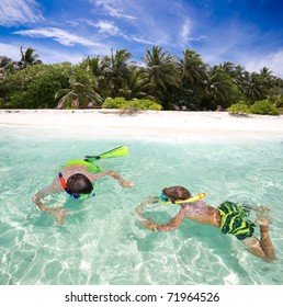 	A Pair Of Kids Snorkeling.