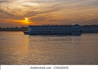 Pair Of Large Luxury Traditional Egyptian River Cruise Boat Sailing On The Nile At Sunset