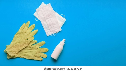 Pair Of Latex Medical Gloves On Color Background. Protection Concept. COVID-19. Facial Masks On The Pile. Epidemic Background. Shortage Of Facial Masks At Drug Store. Quarantine Background. Achocolic 