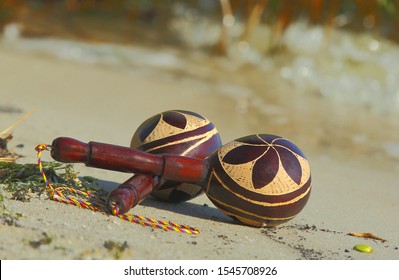 A Pair Of Latin Maracas On The Beach Sand.