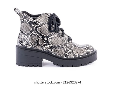 Pair Of Lug Sole Boots With Snake Skin Pattern And Shoe Lace Isolated On White