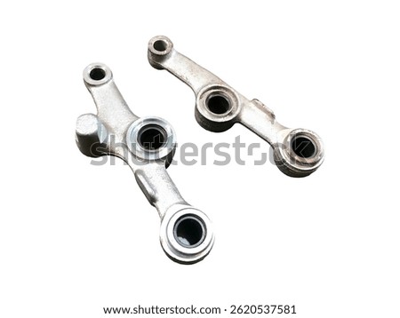 Pair of machined metal linkage components, likely for a mechanical system, shown against a white background