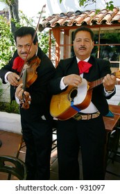 A Pair Of Mariachi Band Players, One On Violin And On On Guitar.  Taken In San Diego, At Jolly Boy Restaurant, In Old Town San Diego