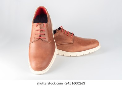 Pair of men's leather shoes in light brown color isolated on a white background - Powered by Shutterstock