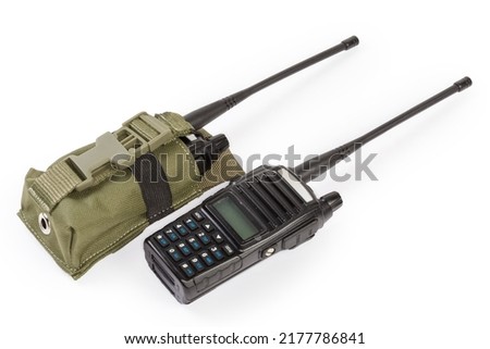 Pair of the modern amateur portable handheld transceivers, so-called walkie-talkie or two-way radio, one of them in textile soft case on a white background
