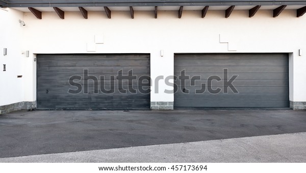Pair of modern garage doors.\
Large automatic up and over garage doors for a wealthy holiday\
home.