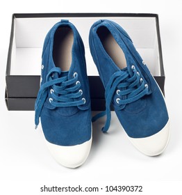 A Pair Of New Blue Shoes On The Shoe Box