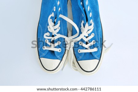 Pair of new blue sneakers isolated on white background