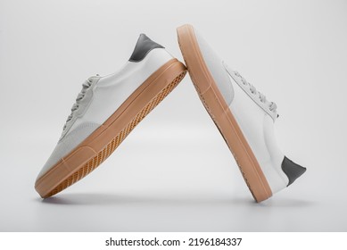 Pair Of New White Sneakers On Blue Background