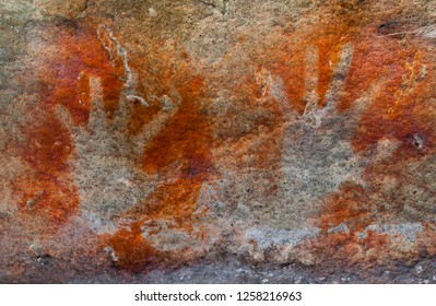 A Pair Of Ochre Hands, Red, Orange, Yellow Hand Prints On A Rock, Aboriginal Art In Queensland, Australia.