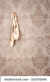 Pair Of Old Ballet Shoes Hanging On A Wall