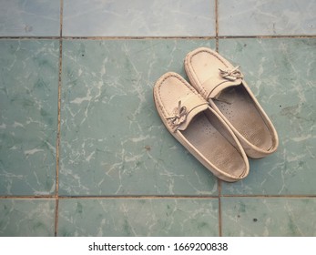 Pair Of Old Female Shoes On The Ground, Top View, Vintage Style.