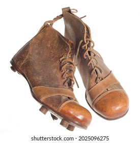 A Pair Of Old Football Boots On A White Background