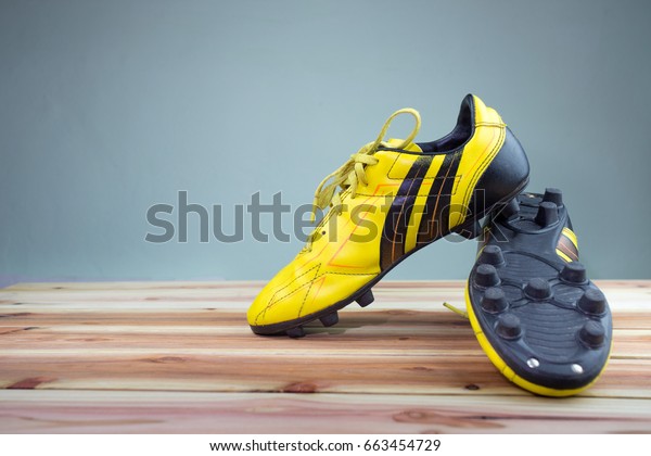 grey and yellow football boots