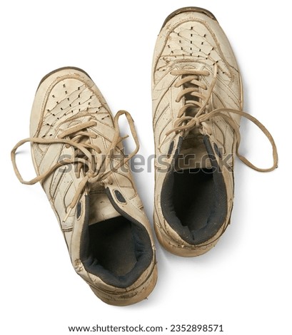 pair of old used shoes isolated white background, dirty sport shoes or sneakers with tied lace taken straight from above