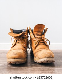 Pair of old yellow working boots - Shutterstock ID 623702603