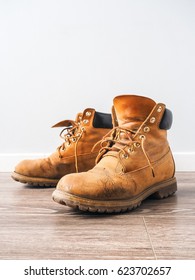 Pair of old yellow working boots - Shutterstock ID 623702657