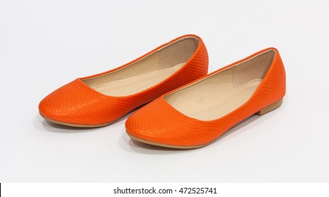 Pair Of Orange Flat Shoes On Plain Background