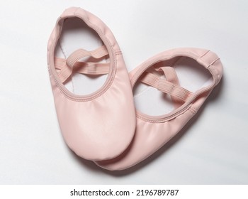 Pair Of Pink Leather Kid Ballet Shoes Close Up View Isolated On Studio Background