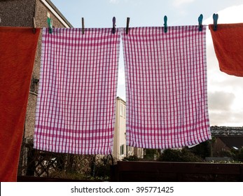 A Pair Of Pink Tea Towels Hanging On A Washing Line.