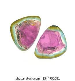 Pair of polished watermelon tourmalines of green and pink colors. Shining gem on white background.