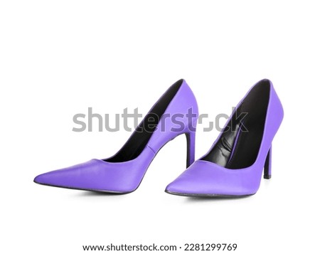 Pair of purple high heeled shoes on white background