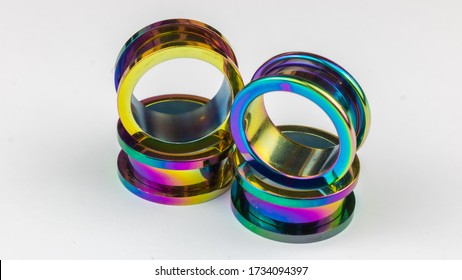 A Pair of rainbow anodized titanium 20mm flesh tunnels