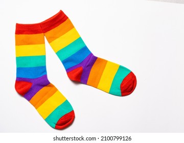 a pair of rainbow colorful socks at white background - Shutterstock ID 2100799126