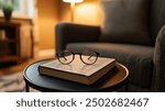 A pair of reading glasses resting atop a closed book on a cozy table. Reading glasses and a closed book, bathed in warm light from a nearby lamp.