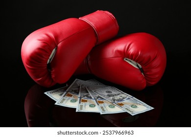 Pair of red boxing gloves and dollar banknotes on black mirror surface - Powered by Shutterstock