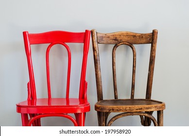Pair of Red and Brown Chairs on a Grey Wall - Shutterstock ID 197958920
