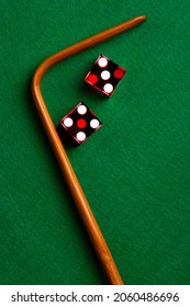 Pair of Red Casino Dice and Crap Stick on green felt table