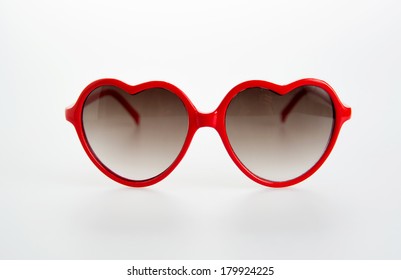 Pair Of Red Heart Shaped Sunglasses On White Background