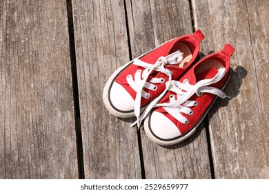 Pair of red shoes on wooden surface, top view. Space for text - Powered by Shutterstock