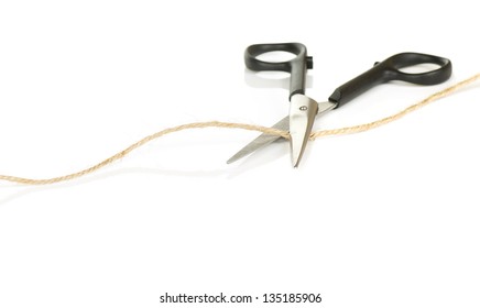 Pair Of Scissors Cutting A Piece Of String