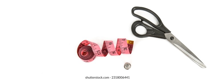 A pair of scissors,measuring tape and thimble isolated on a white background. Free space for text. Wide photo. Collage.