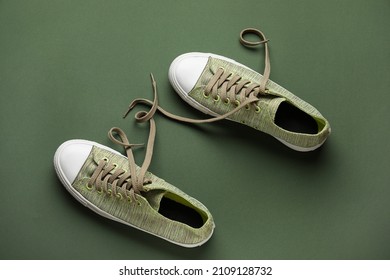 Pair Of Shoes With Untied Laces On Green Background