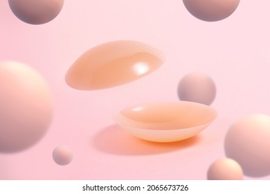 A pair of silicone sticker pad to cover nipples on pink background